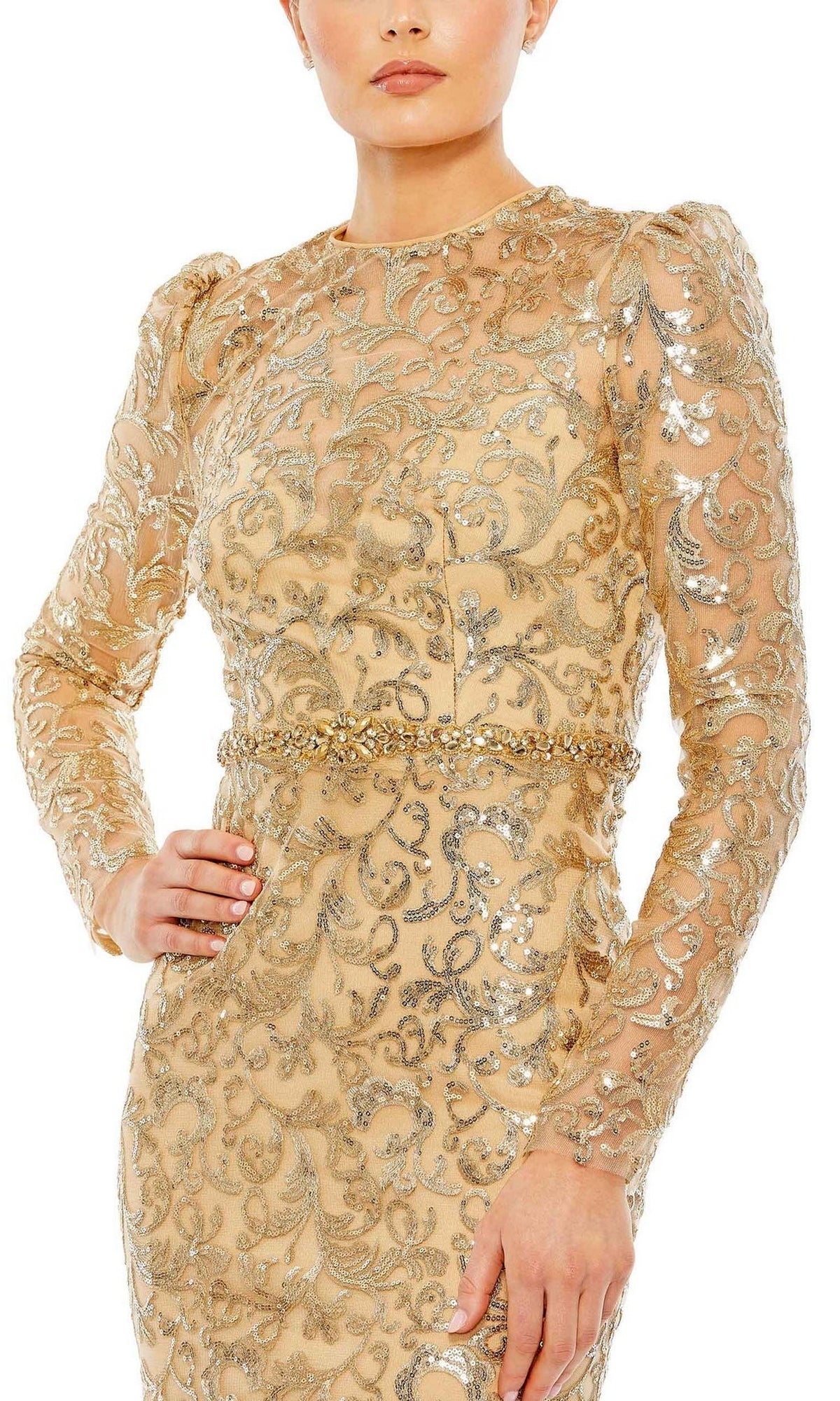 A person poses with one hand on hip in the Mac Duggal 68011 Long Beaded-Lace Formal Dress, a gold and silver sequin embroidered, long-sleeve gown with intricate patterns—an elegant choice for a mother of the bride.